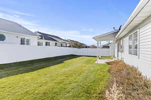 Fenced backyard featuring a patio and a residential view