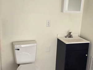 Half bathroom with vanity and toilet