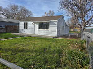 View of front of house with roof with shingles and a patio