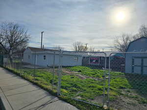 View of front of home with a fenced front yard and a gate