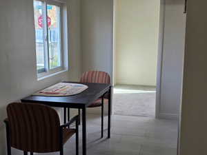 Dining space with light colored carpet and baseboards