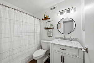 Bathroom featuring curtained shower and vanity