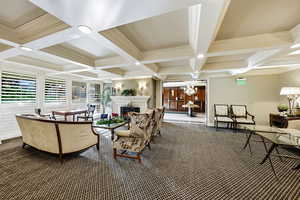 Community lobby with coffered ceiling, beam ceiling, ornamental molding, and recessed lighting