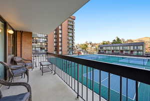 Balcony featuring a tennis court