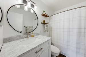 Full bathroom featuring a shower with shower curtain and vanity