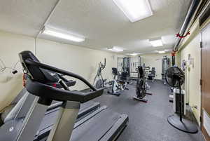Workout area featuring a textured ceiling