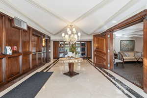 Common area with coffered ceiling, crown molding, and beam ceiling