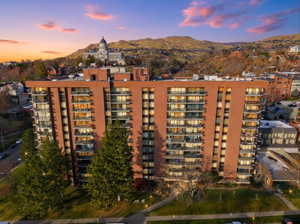 Property at dusk featuring a view of apartment building / complex and a mountain view