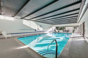 Indoor community pool featuring a patio and a jacuzzi