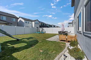 Fenced backyard featuring a patio area and a residential view