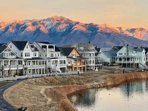 Back of house at dusk featuring a mountain view