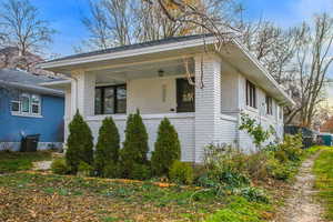 View of side of property featuring brick siding and a central AC unit