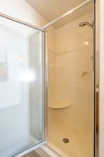 Bathroom featuring a stall shower and a textured ceiling