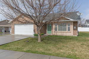 View of front of property featuring driveway, brick siding, an attached garage, and a shingled roof
