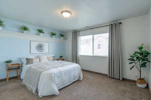 Bedroom with carpet and a textured ceiling