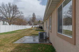 Fenced backyard featuring a mountain view and a patio area