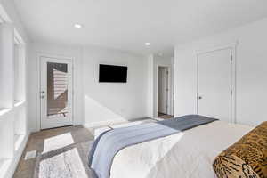 Carpeted bedroom featuring access to exterior and recessed lighting