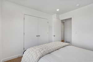 Bedroom featuring a closet, carpet floors, and recessed lighting