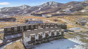 Snowy aerial view featuring a mountain view