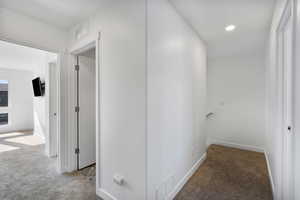 Hall featuring carpet and recessed lighting