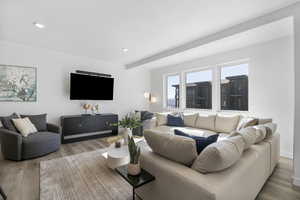 Living area with wood finished floors and recessed lighting