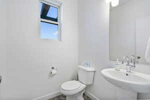 Bathroom with baseboards and toilet