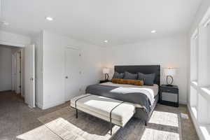 Bedroom with light colored carpet and recessed lighting