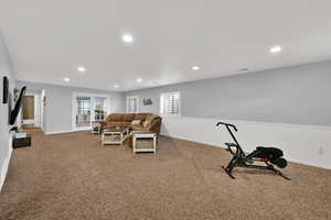 Carpeted living room featuring recessed lighting