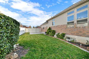 Fenced backyard with a patio and a gate