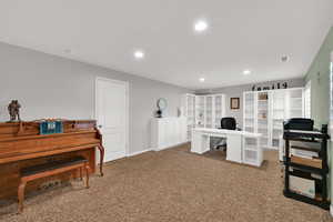 Office space with recessed lighting and light carpet