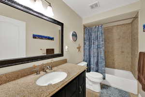 Full bathroom featuring shower / bathtub combination with curtain and vanity