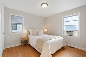Bedroom featuring light wood-style floors and cooling unit