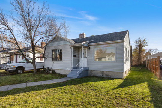Bungalow-style house featuring a chimney