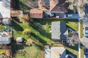 Aerial view of property and surrounding area featuring nearby suburban area