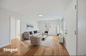 Living room with light wood-style flooring and baseboards