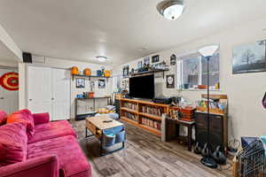 Living area featuring a textured ceiling and wood finished floors