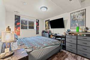 Bedroom with dark wood-style floors and a textured ceiling