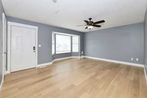 Entrance foyer featuring light wood finished floors and ceiling fan