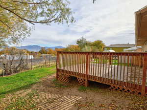 Wooden terrace featuring a mountain view