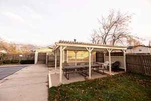 Fenced backyard with a patio and a pergola