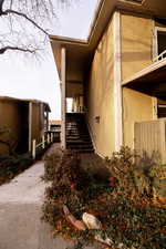 View of home's exterior featuring stairs and stucco siding