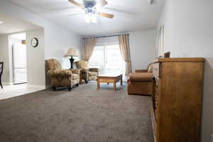 Sitting room featuring light colored carpet and a ceiling fan