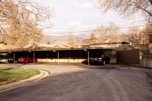 Covered parking lot featuring a mountain view