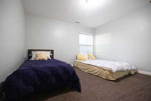 Carpeted bedroom with baseboards