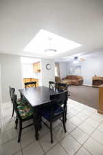 Dining space featuring a ceiling fan and light tile patterned floors