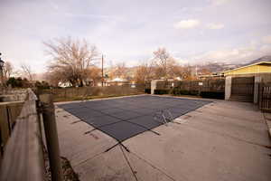 Community pool featuring a fenced backyard and a patio