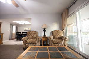 Living area featuring ceiling fan and light tile patterned floors