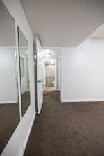 Corridor with dark colored carpet