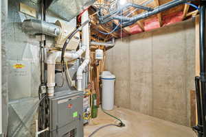 Utility room featuring heating unit