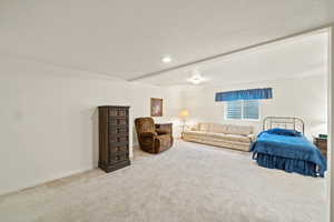 Living area with carpet and a textured ceiling